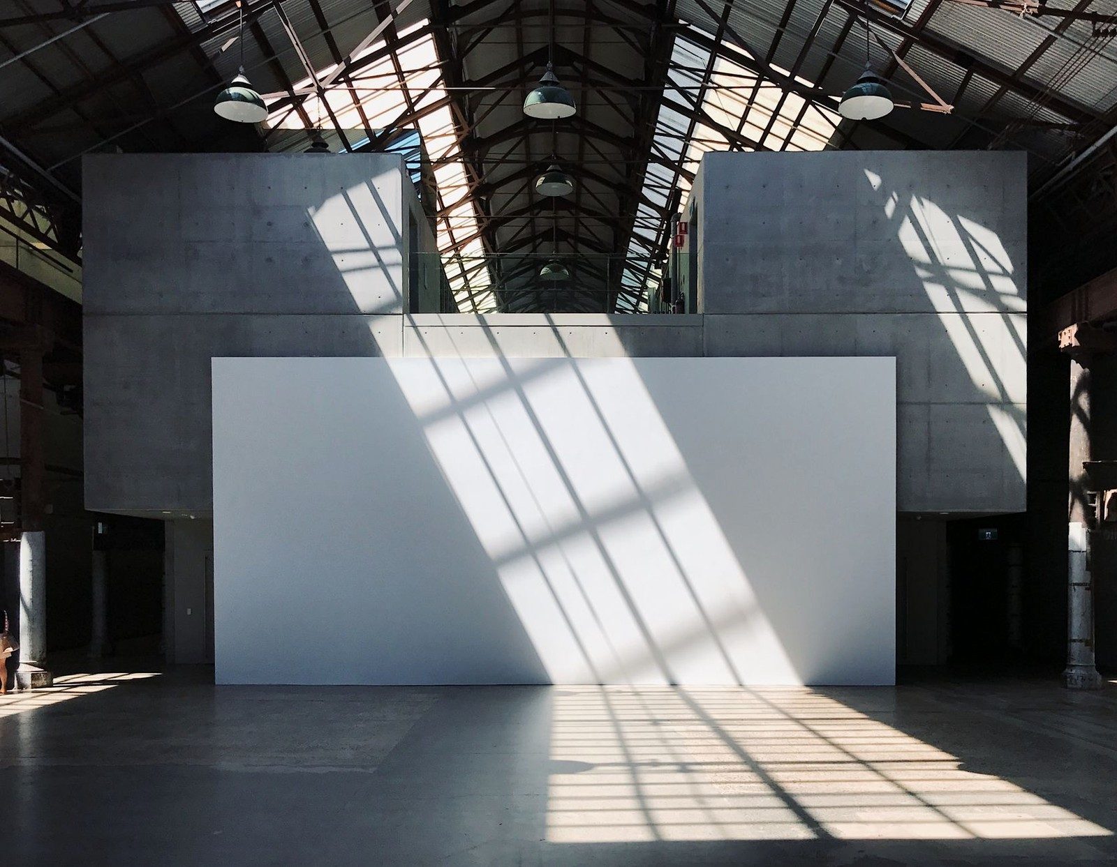 Light falling across a concrete hall, from the MHMD Creative site