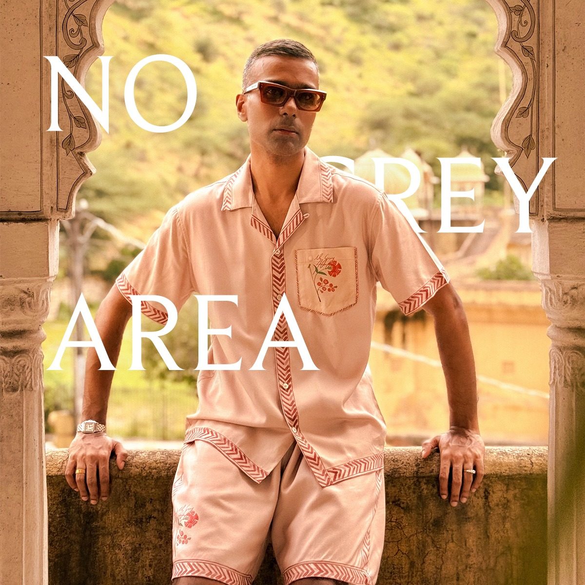 No Grey Area campaign ad with a model in a coral shirt